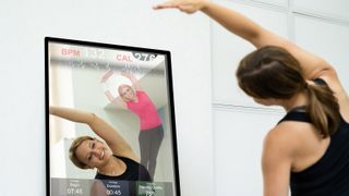 WOman using smart mirror for workouts