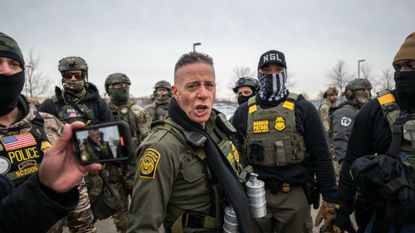 Border Patrol Chief Gregory Bovino, center, and law enforcement officers outside the Bishop Henry Whipple Federal Building in St. Paul, Minnesota, US, on Thursday, Jan. 8, 2026. An Immigration and Customs Enforcement officer fatally shot a woman during a confrontation in Minneapolis, sparking an uproar over the presence of ICE agents in the city and heightening political divisions around the Trump administration's migrant crackdown. Photographer: Victor J. Blue/Bloomberg via Getty Images