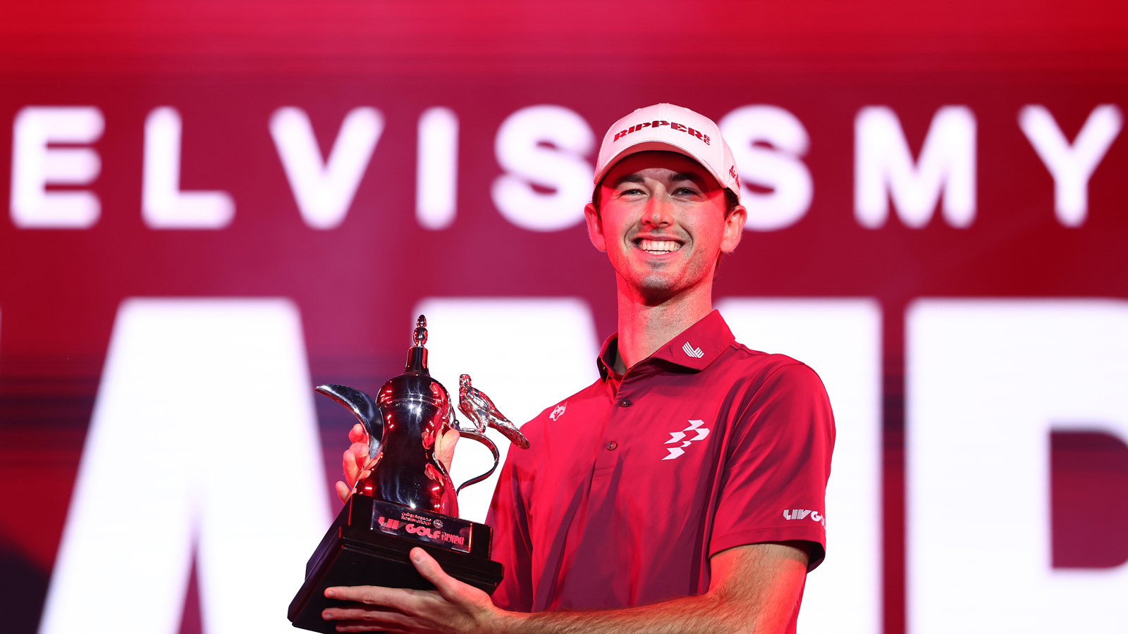 Elvis Smylie holds a LIV Golf Riyadh trophy