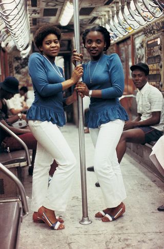 Two women on the subway wearing matches outfits