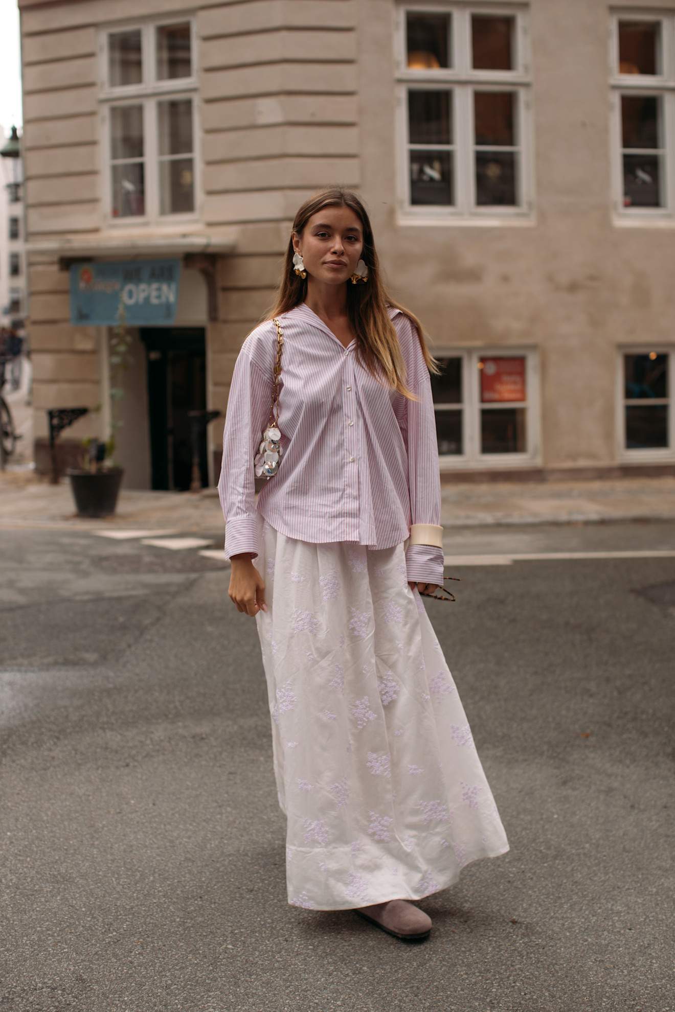 fashion week attendee wearing white button-down shirt and white maxi skirt