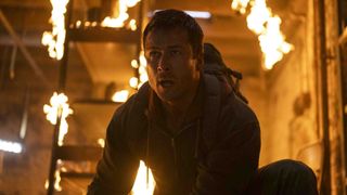 Glen Powell in a burning building in The Running Man