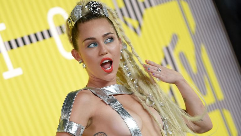 Miley Cyrus performs on stage in a chastity belt inspired outfit