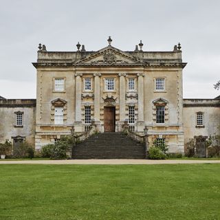 exterior of grade I listed Georgian manor house with steps up to front door