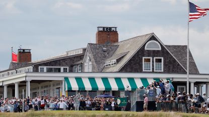 Bryson DeChambeau tees off in front of the Shinnecock Hills clubhouse