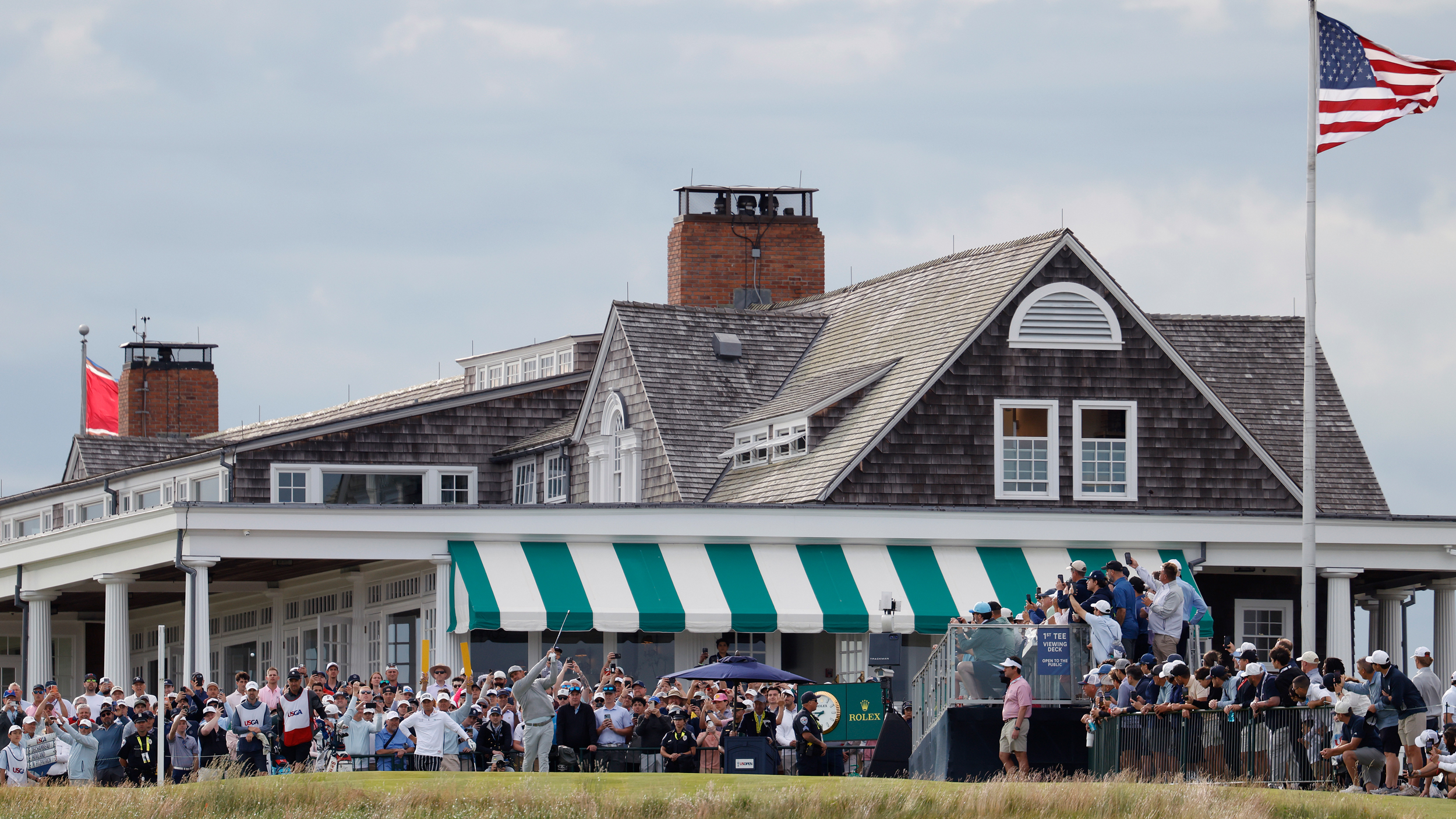 Bryson DeChambeau tees off in front of the Shinnecock Hills clubhouse