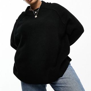 model wearing black oversized jumper