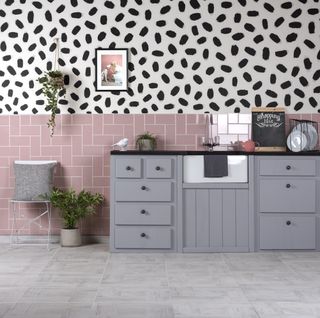 pink kitchen tiles with grey units and floor