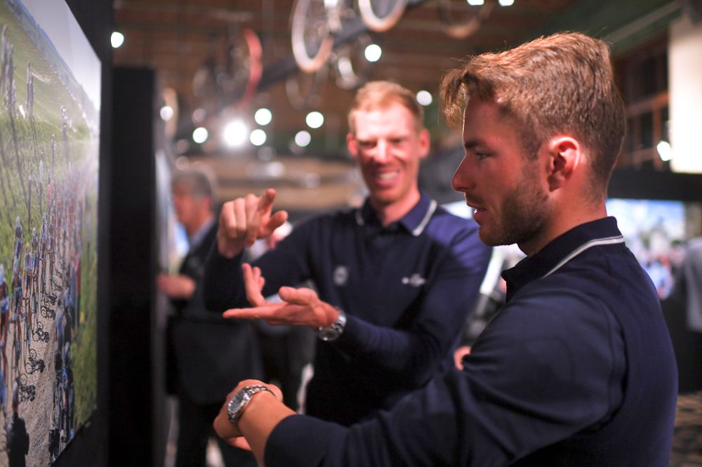 Tim Declercq and Florian S&eacute;n&eacute;chal check out photos on display at the QuickStep presentation