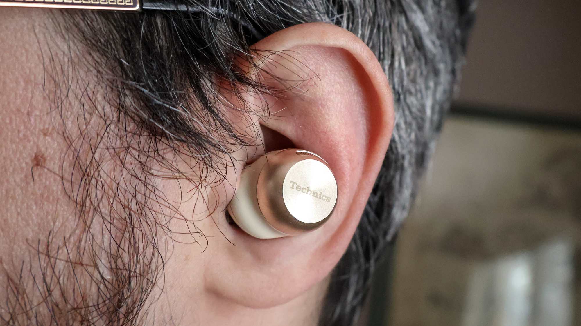 A Technics EAH-AZ100 Wireless Earbud in an ear