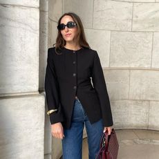 anna wears black aligne blazer jeans and burgundy bottega bag