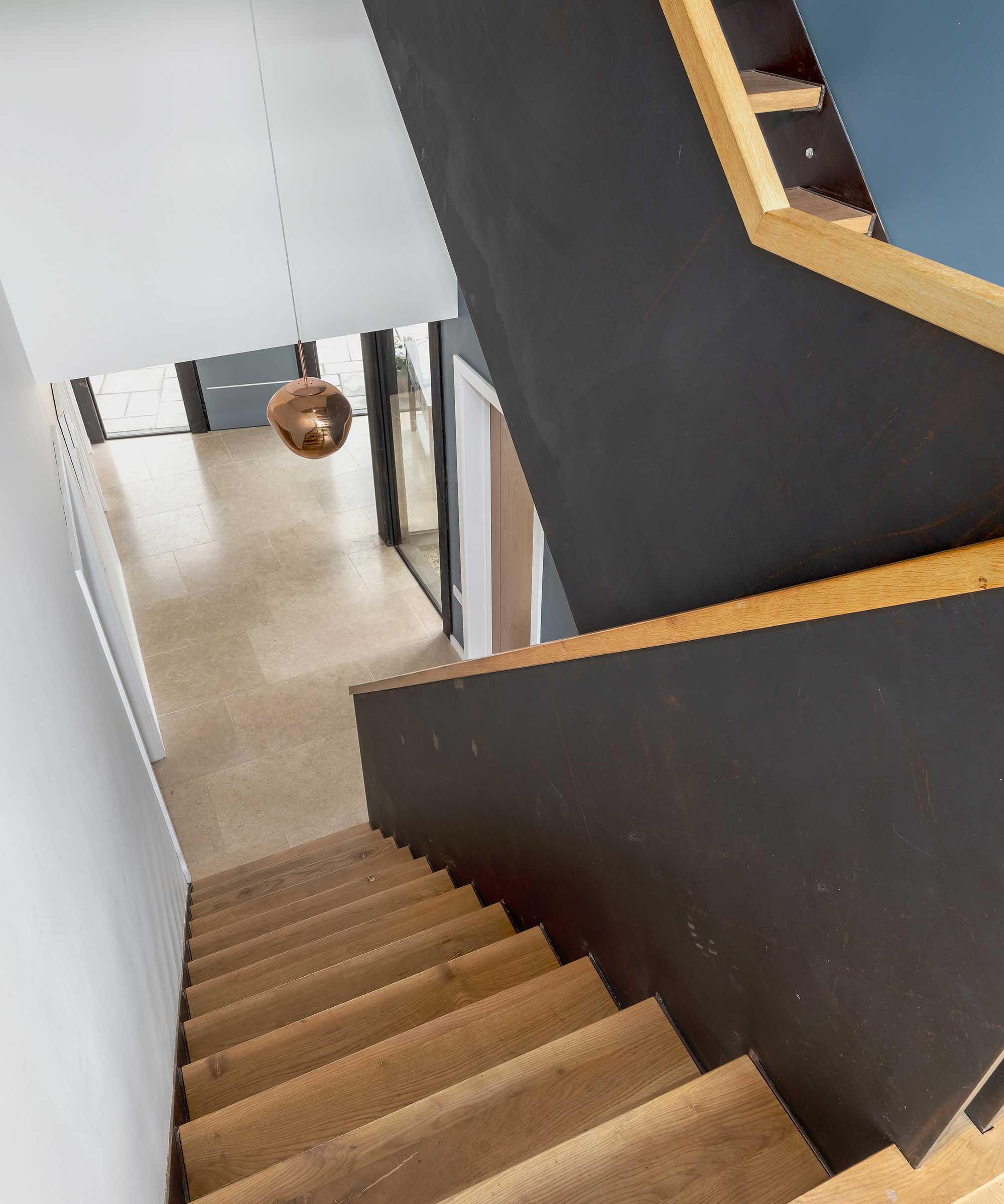 a view down a staircase into a new hallway in a self build home