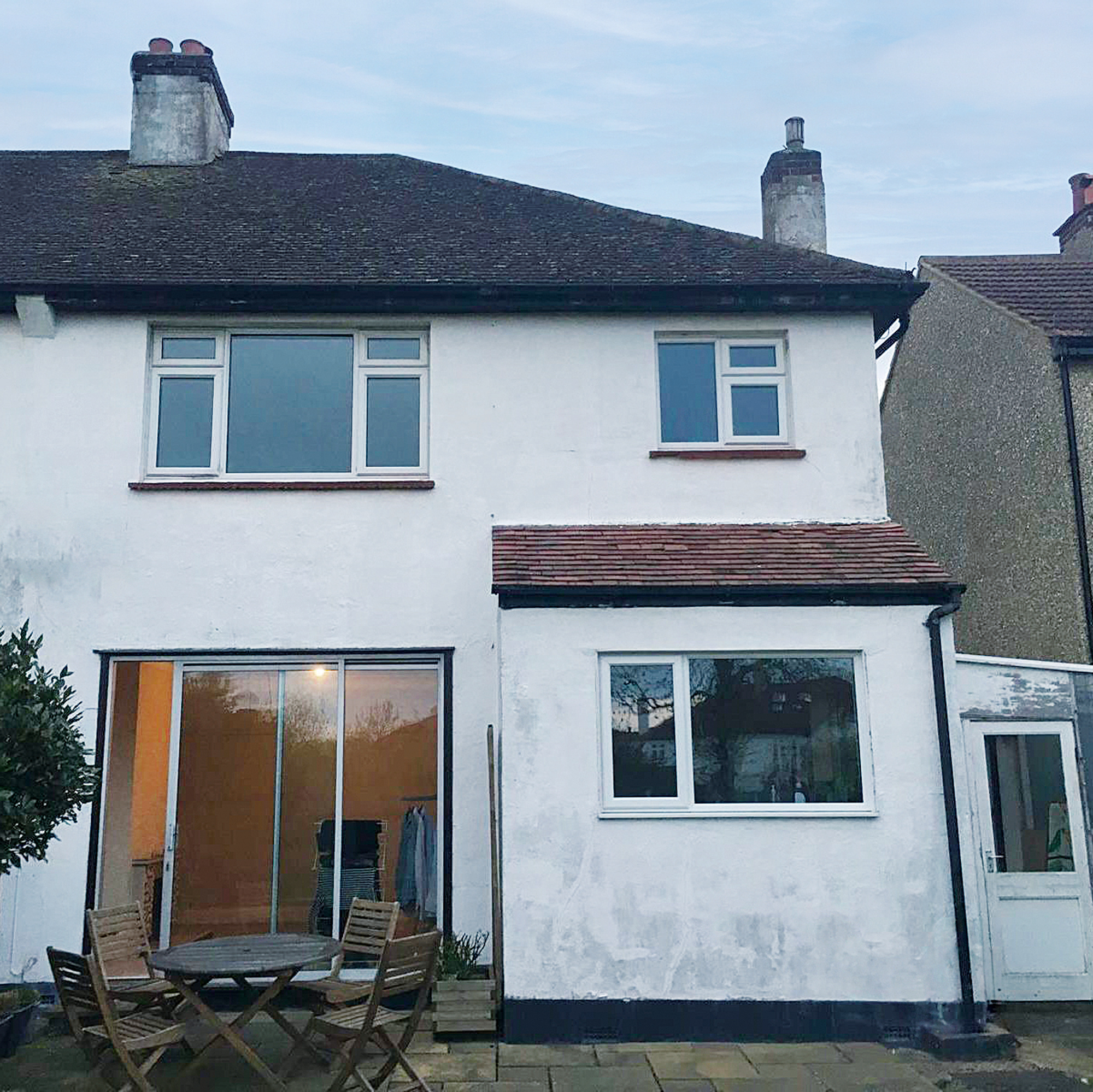 the rear view of a tired, old terraced house
