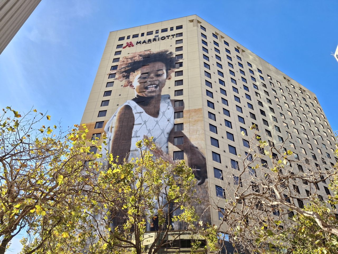 mural of a girl on a high-rise building in Oakland shot by a Galaxy A35