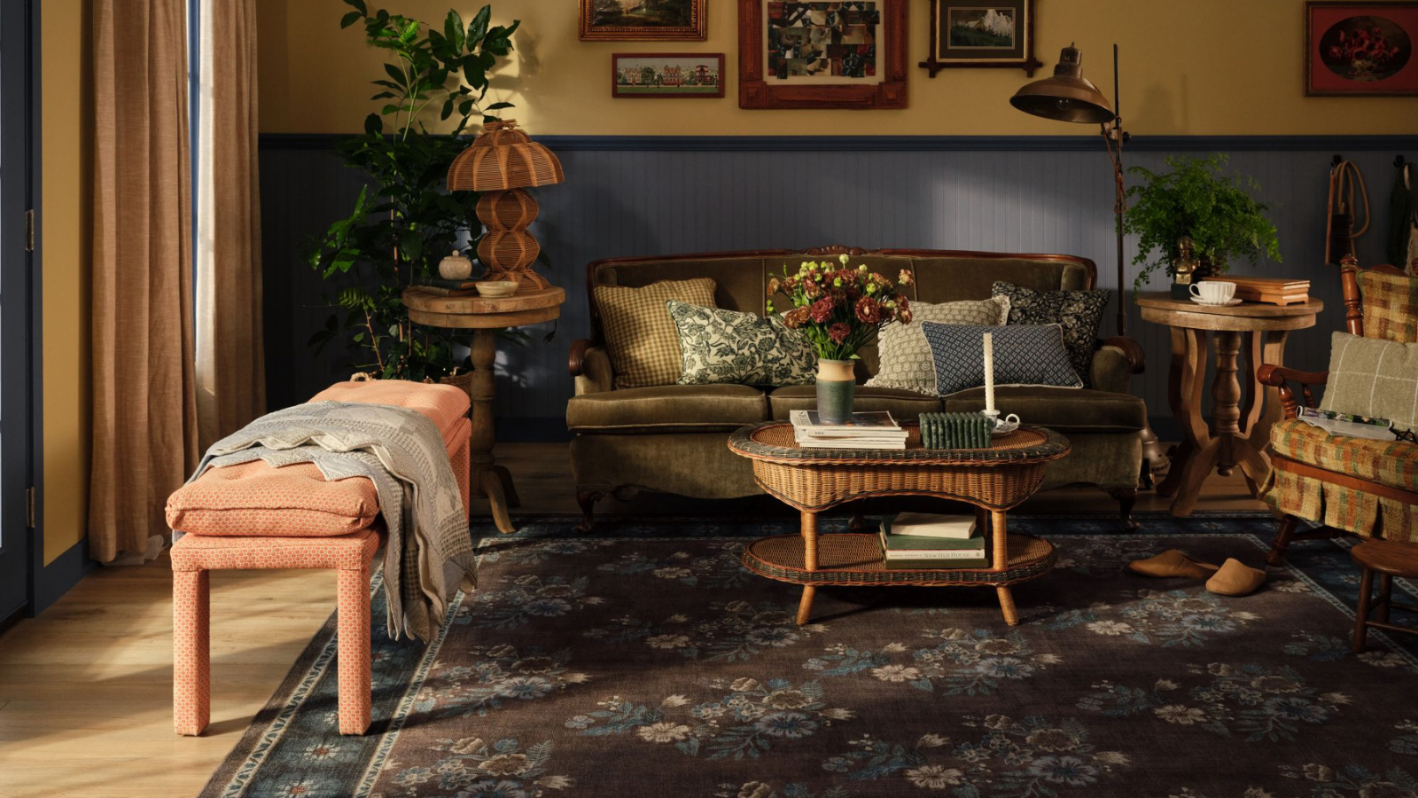 a cozy living room with a large floral area rug, and vintage inspired furnishings and decor