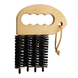 Wooden blind brush with finger holes and four black bristles on a white background