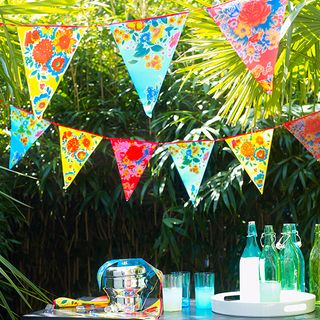 bunting flag with glass bottles with glasses