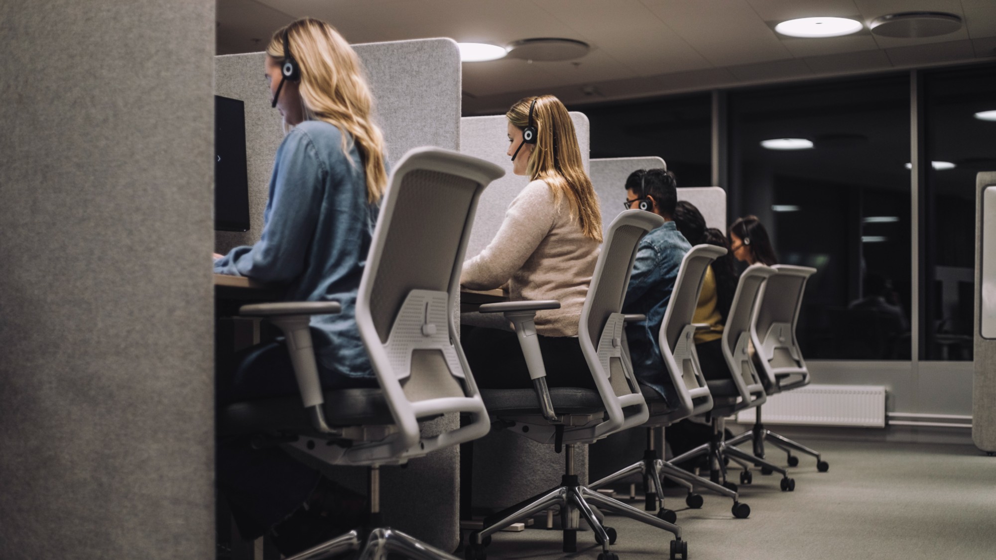 A stock photo of employees working at a call center.