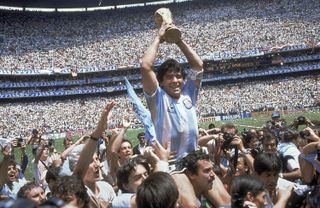 Diego Maradona holds up the World Cup in 1986