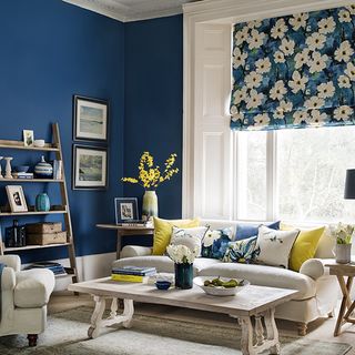 room with open wooden shelves and dark blue wall