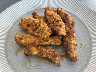 Cooked honey-garlic chicken tenders on a plate