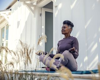 Gardener meditates on deck