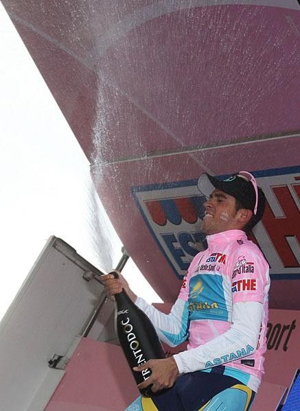 Contador busts open the bubbly after holding his pink jersey by just four seconds.