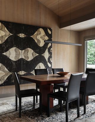 minimalist dining room with dark wood table and light wood walls