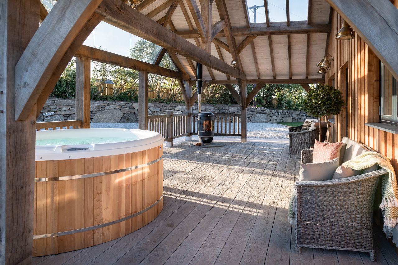 exterior veranda with seating and hot tub