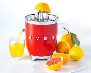 Image of Smeg juicer with various citrus fruits