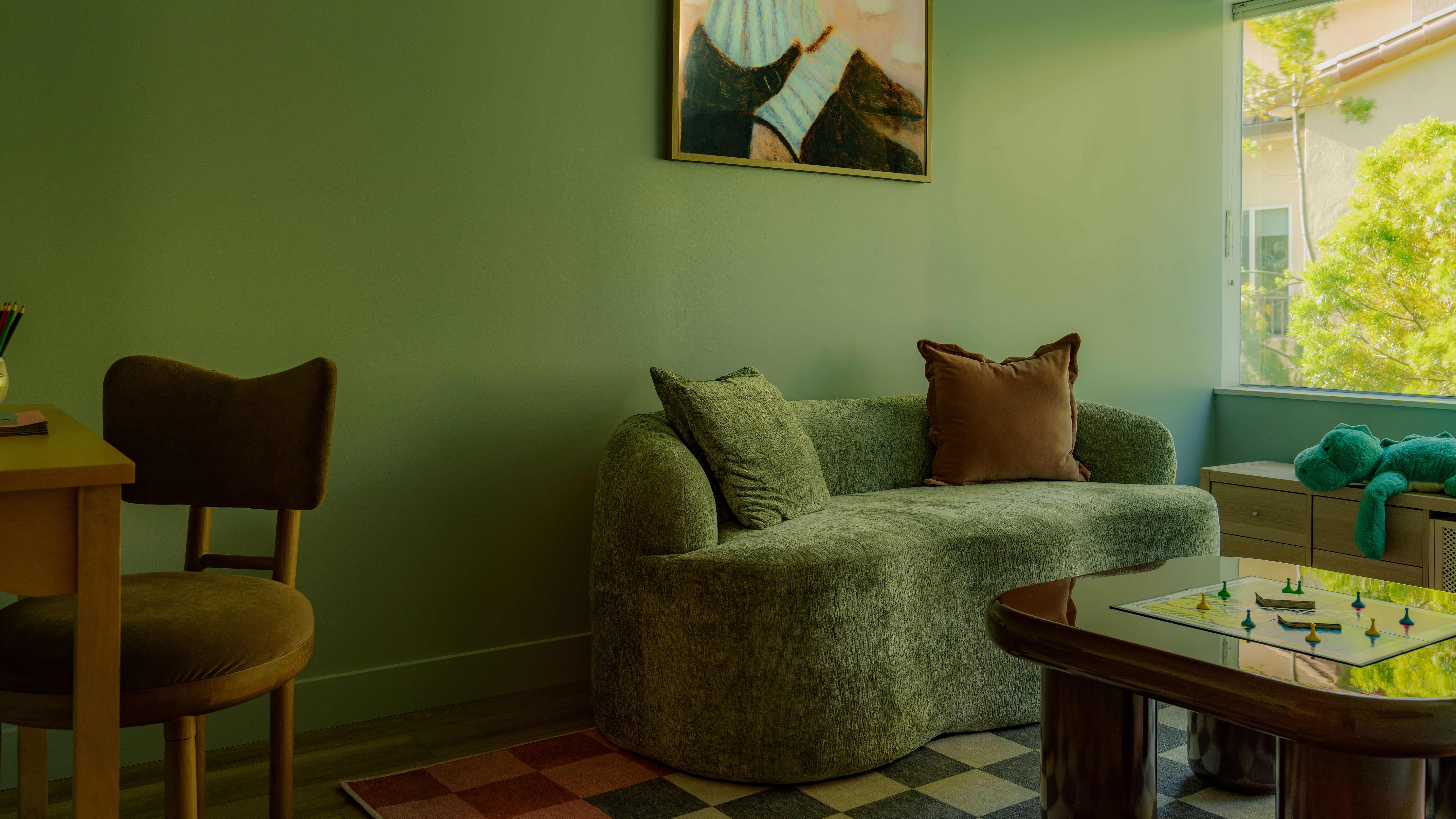 green living room with green sofa and checkerboard rug