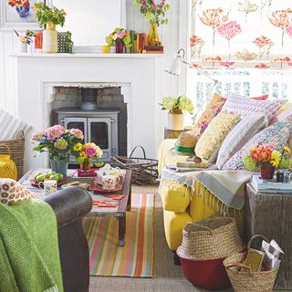 living room with fire stove sofa and decorative cushions