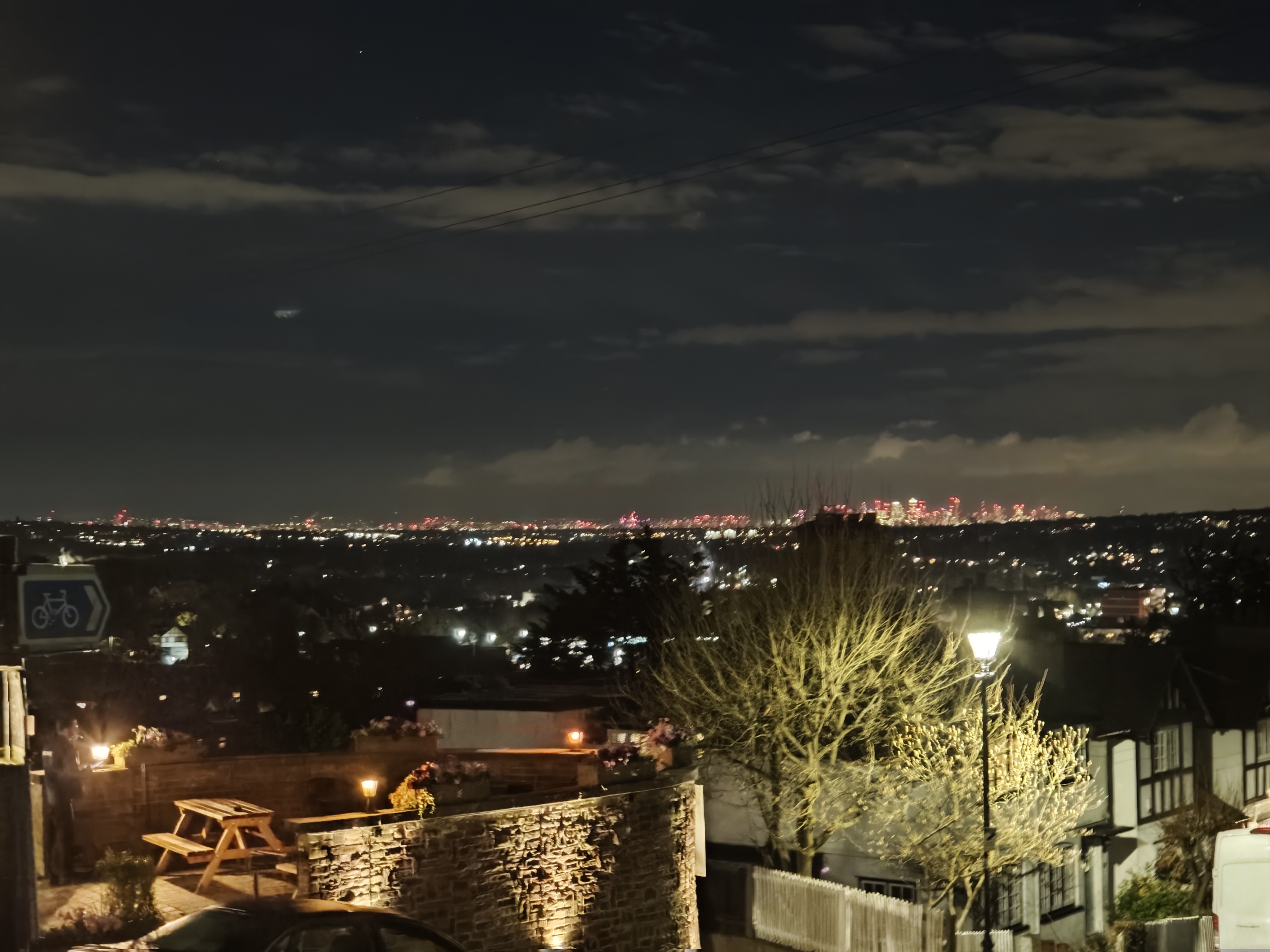 The skyline of Canary Wharf from a hillside at night