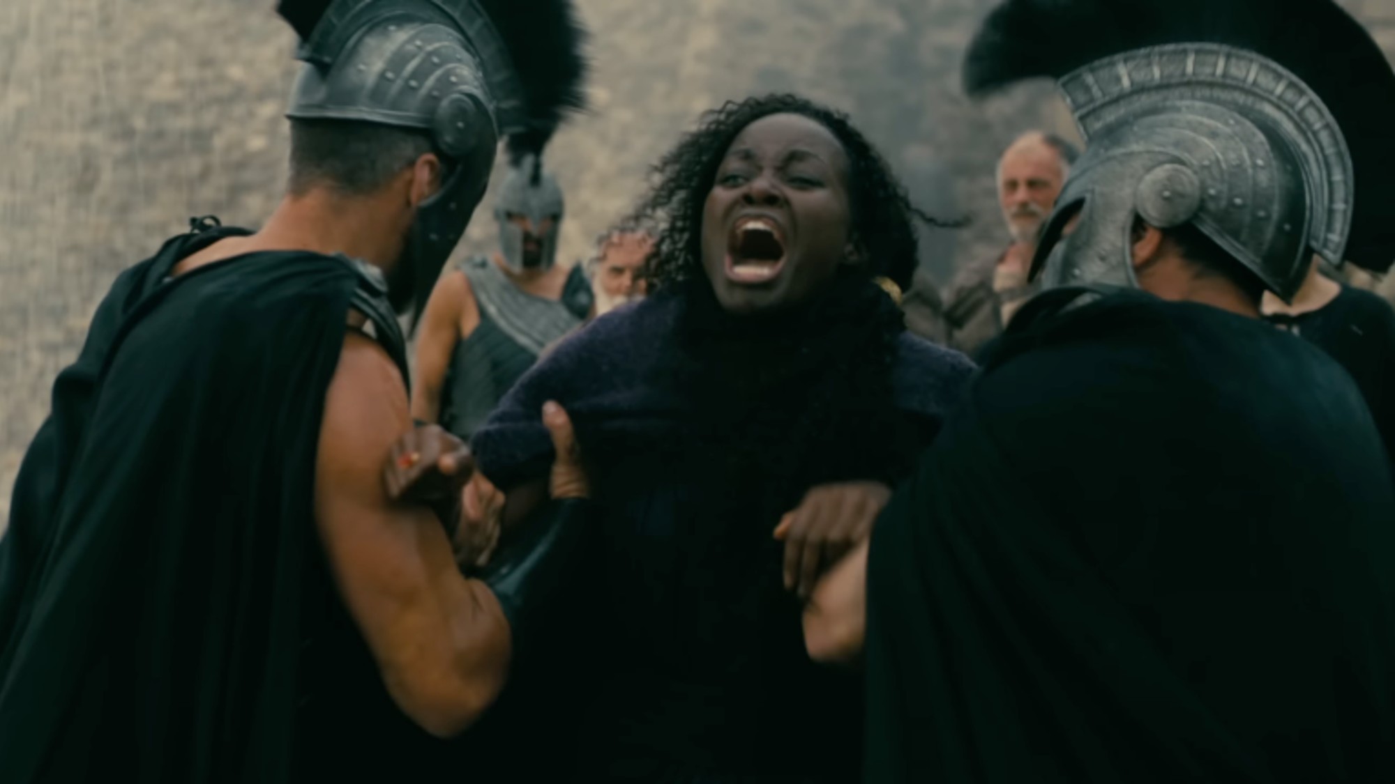 Lupita Nyong'o screaming while being held by two soldiers in The Odyssey