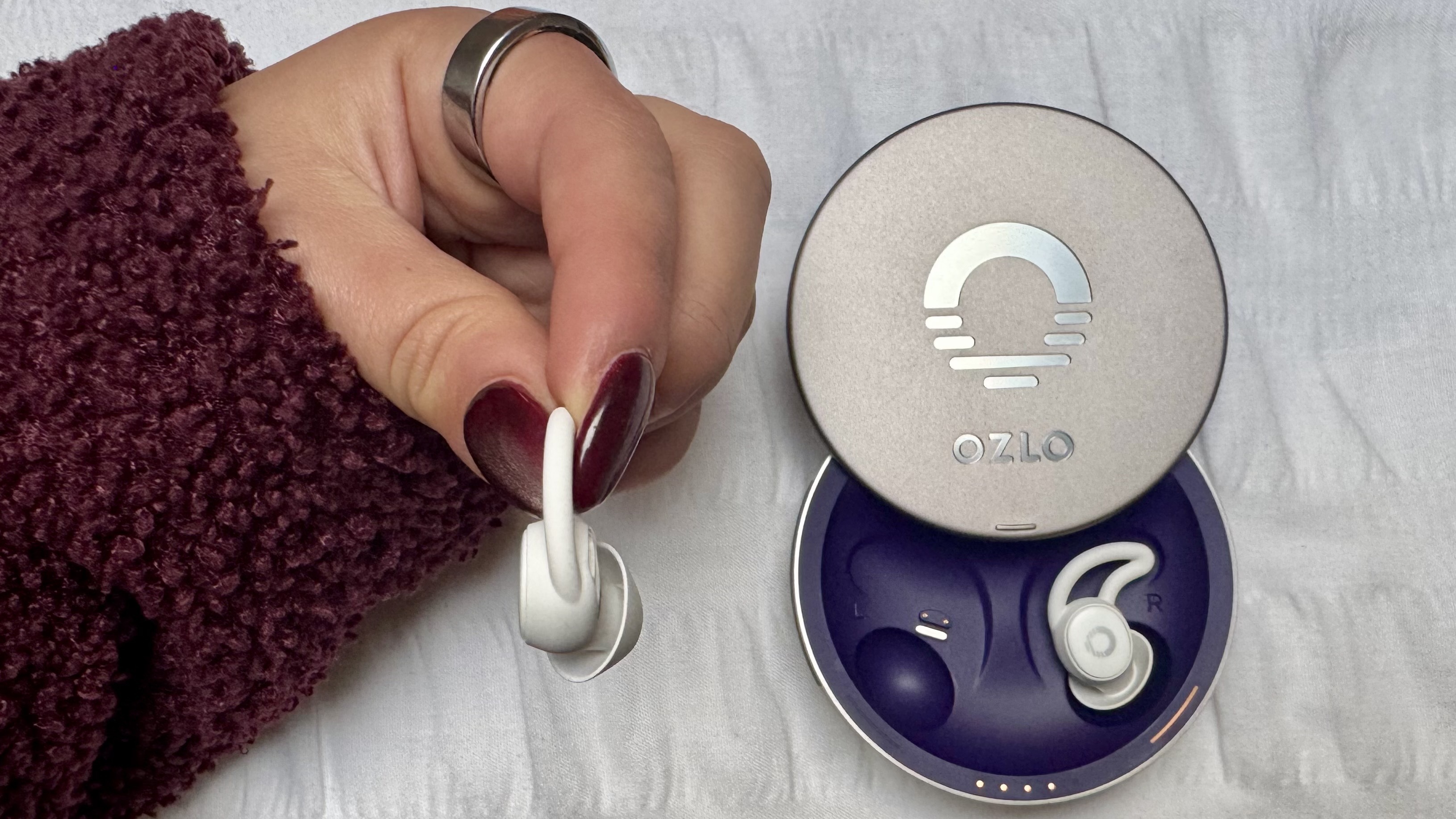 White Ozlo Sleepbuds in purple case