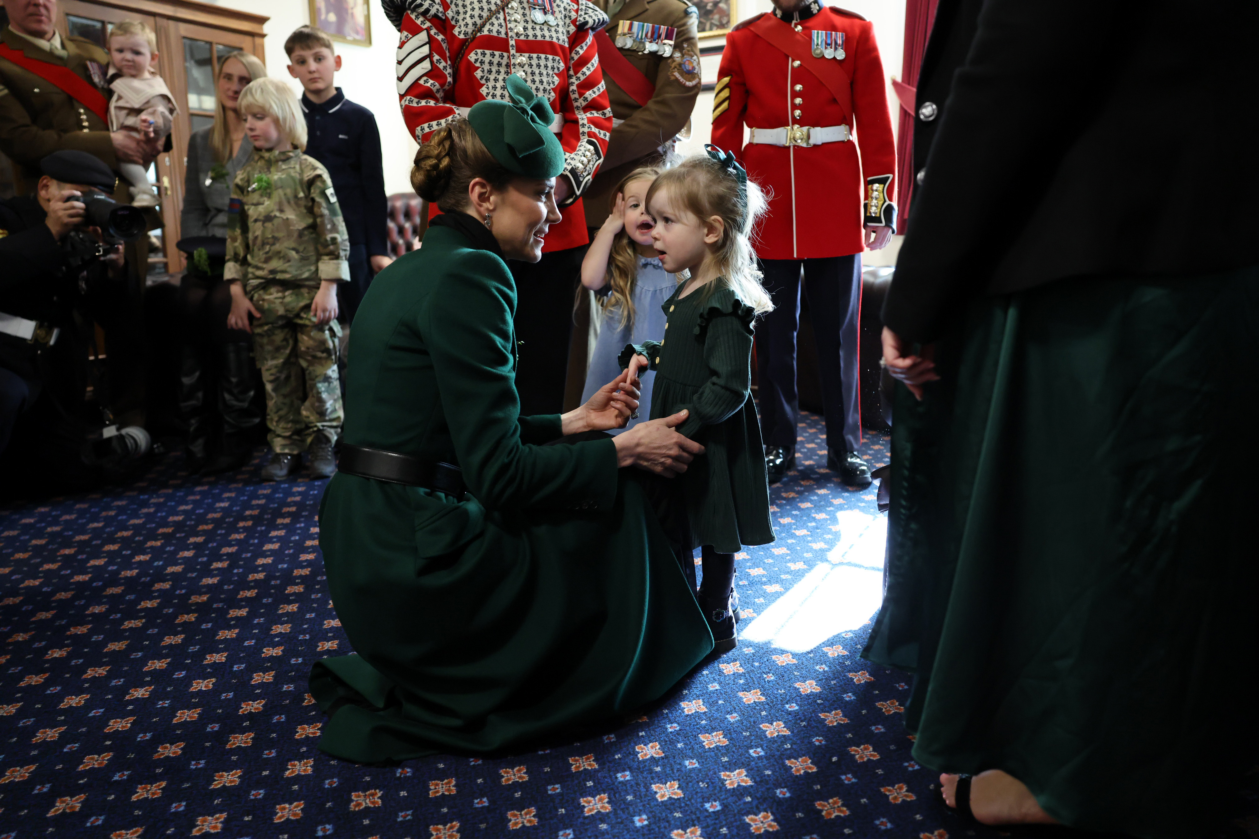 Princess Kate kneeling down talking to little girls