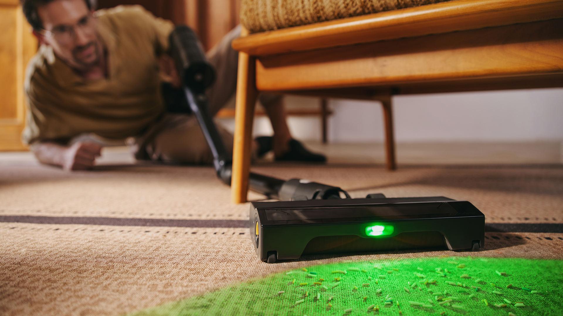 Man cleaning with the Roborock H60 Ultra, with wand bend forward