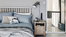 bedroom with grey wall and bedside table