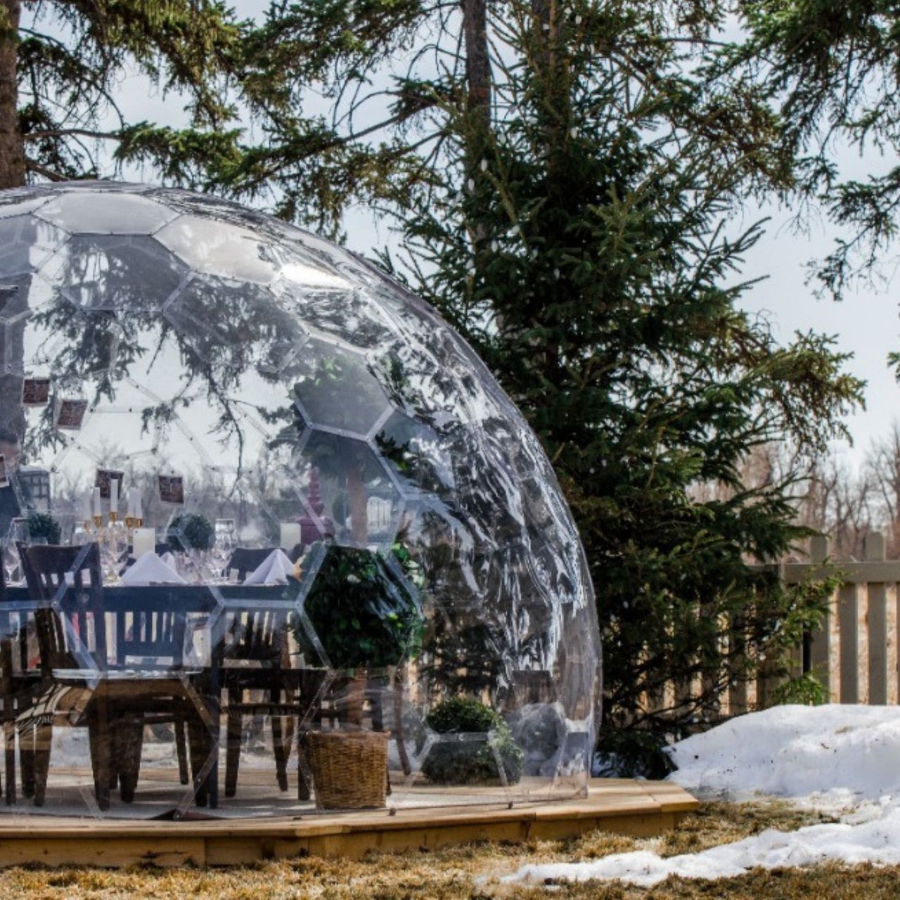 Bubble dome kitted out with dining set in a snowy garden