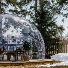 Bubble dome kitted out with dining set in a snowy garden