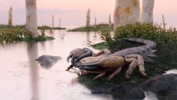 A reconstruction of a brown and black scorpion on the edge of a river bank.
