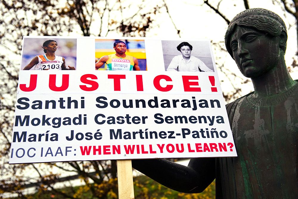 A placard placed on a statue by the human-rights advocacy group dedicated to intersexed (DSD women) persons is seen during a protest at International Olympic Committee (IOC) headquarters on November 19, 2009 in Lausanne