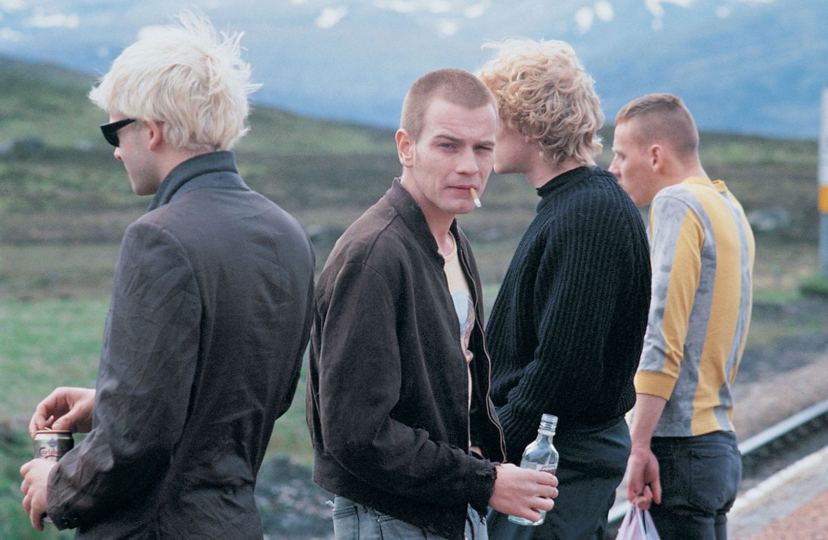 A still image from the film Trainspotting showing four people in the countryside