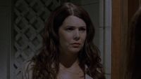 Lorelai looking confused in a jacket at the door of Richard and Emily's house.