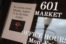 A sign in the window of a business in Metropolis, Illinois, tells visitors they will be closed on August 31 for the solar eclipse.