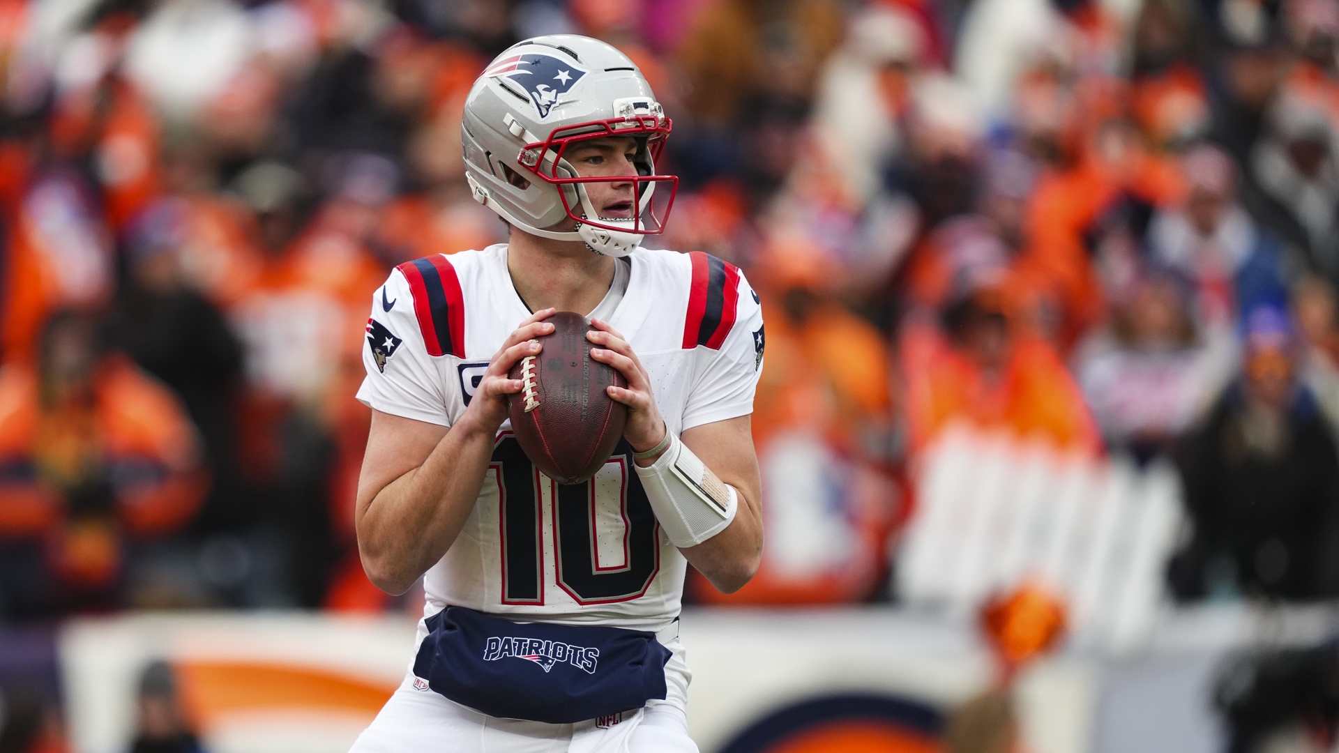 Drake Maye of the New England Patriots drops back to pass during an NFL football game.