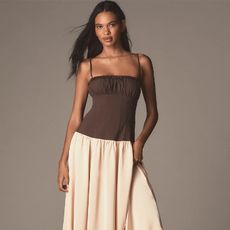 model wears a dress with brown torso and satin skirt