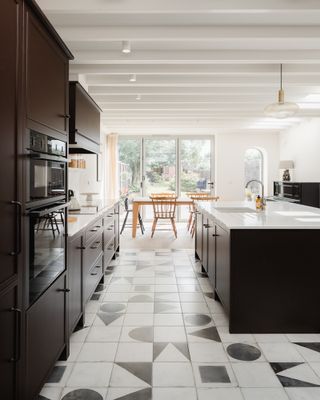 black and white kitchen with creative floor tiles