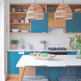 Blue and wood modern kitchen with white worktops