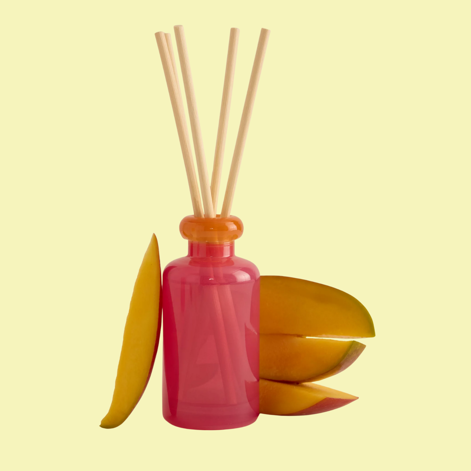 A pink and orange reed diffuser